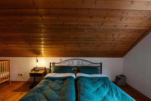 a bedroom with a bed and a wooden ceiling at Ferienwohnung Pop s Huus 35226 in Holtland