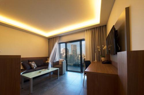 a living room with a couch and a table at Urban Central Suites - Beirut in Beirut