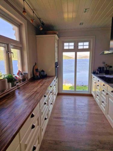 a large kitchen with a large wooden counter top at Kræmarvika Vila in Tromsø