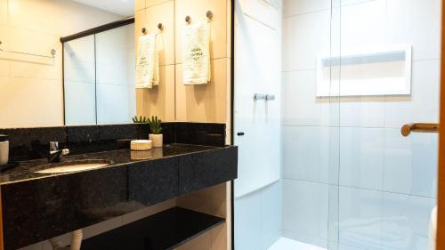 a bathroom with a sink and a shower at Makia Beach Experience Muro Alto Porto de Galinhas in Ipojuca
