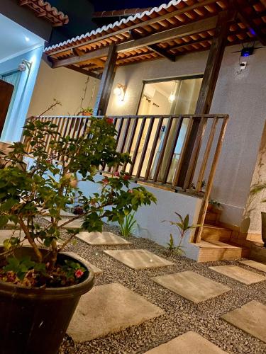 a house with a staircase and a potted plant at Pousada Só Lazer in Touros