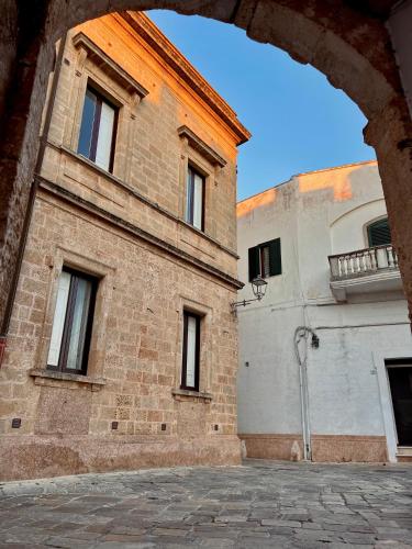 a large brick building with windows on the side of it at La Casetta Casa Vacanze in Alessano