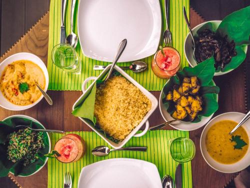 a table topped with plates of food and bowls of food at Aqua Dunhinda Villa in Kandy