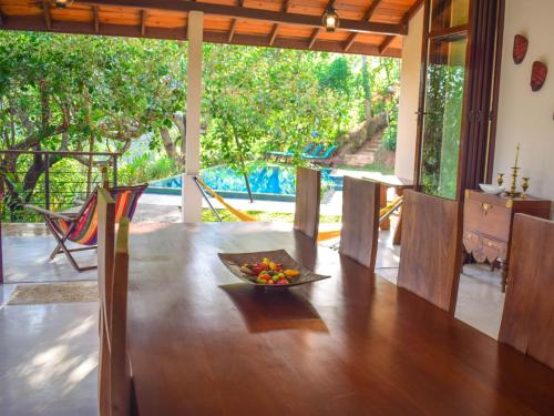 a room with a table with a bowl of fruit on it at Aqua Dunhinda Villa in Kandy