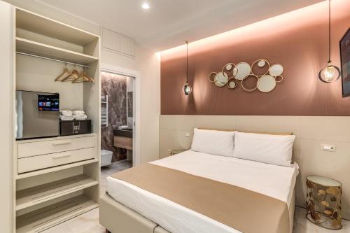 a bedroom with a large bed and a tv at Le stanze di Venere in Naples