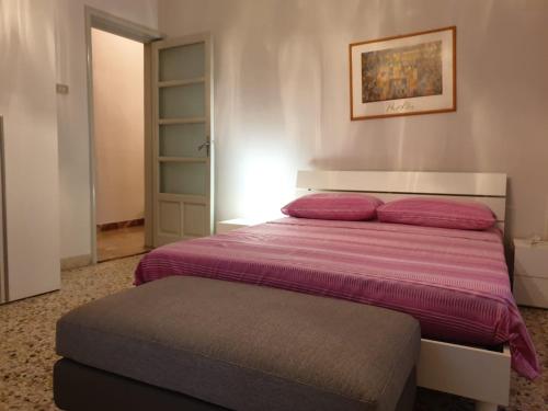 a bedroom with a bed with a purple blanket at Risorgimento House in Catania