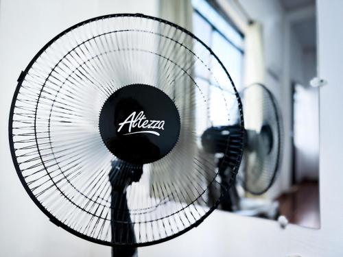 a white fan with theania written on it at Casa Oasis in Leticia