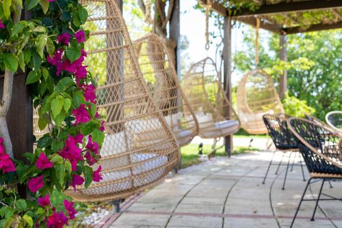 a group of chairs sitting on a patio with flowers at Vista Marina Apartamentos Turisticos in Portimão