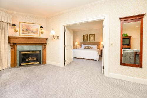 a bedroom with a bed and a fireplace at Fairhaven Village Inn in Bellingham