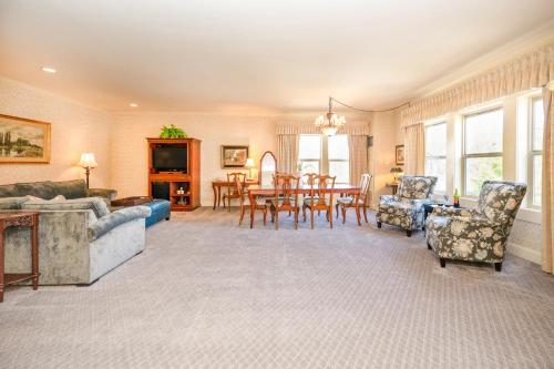 a living room with a couch and a table and chairs at Fairhaven Village Inn in Bellingham