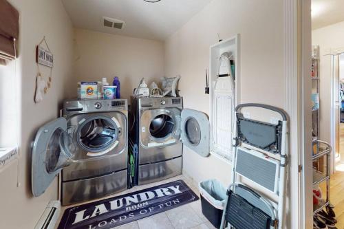 a laundry room with two washing machines in it at Tacit Shadow Resort Aviator Queen Suite, Gym, Coffee Bar, Hot-Tub, Free Laundry, Food Available in Parowan