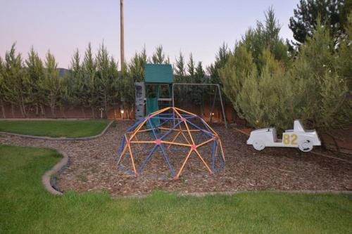 a small playground in a yard with a play equipment at Tacit Shadow Resort Aviator Queen Suite, Gym, Coffee Bar, Hot-Tub, Free Laundry, Food Available in Parowan