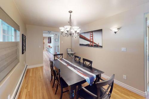 a dining room with a table and chairs and a chandelier at Tacit Shadow Resort Aviator Queen Suite, Gym, Coffee Bar, Hot-Tub, Free Laundry, Food Available in Parowan