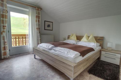 a bedroom with a large bed and a window at Garni Sonnegg in Petersberg