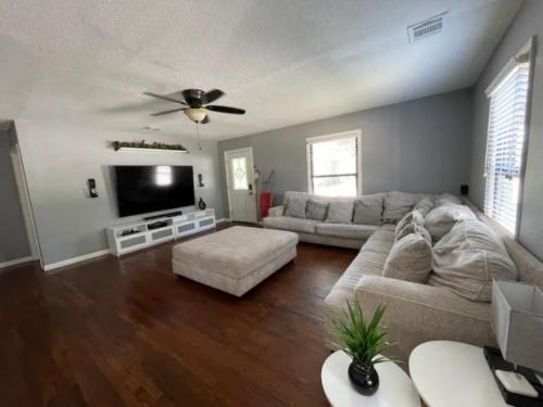 a living room with a couch and a flat screen tv at Home in Fort Worth in Fort Worth