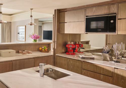 a kitchen with a red machine on the counter at Mandarin Oriental, Singapore in Singapore