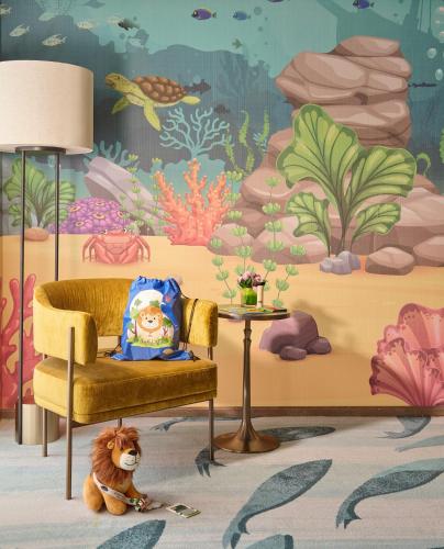 a living room with a painting of the ocean at Mandarin Oriental, Singapore in Singapore