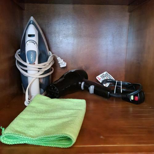a hair dryer and a towel on a wooden table at Habitaciones San Marcos 3 in Tequila