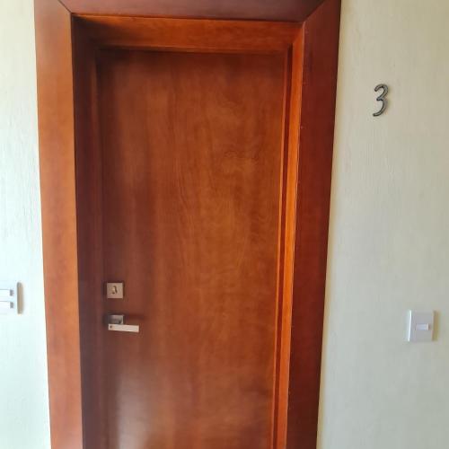 a wooden door in a room with the number three on it at Habitaciones San Marcos 3 in Tequila