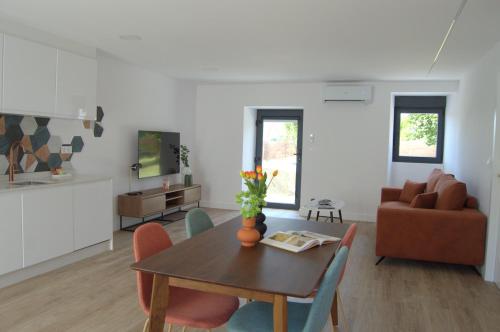 a living room with a table and chairs and a couch at Valda in Muxia