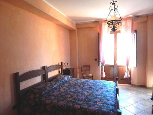 a bedroom with a bed in a room with a window at Tenuta Montelaura in Forino