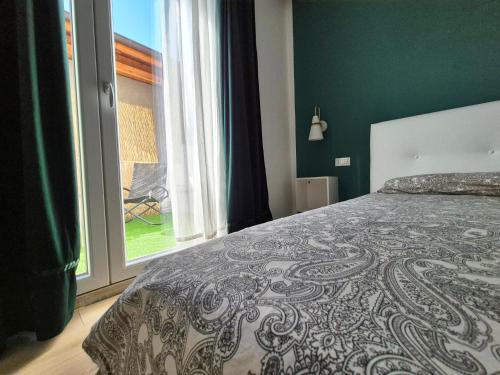 a bedroom with a bed and a large window at La casa di Athina in Celano