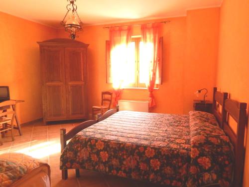 a bedroom with a bed in a room with orange walls at Tenuta Montelaura in Forino