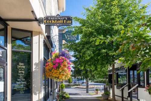 a street with flowers hanging off the side of a building at Fairhaven Village Inn in Bellingham