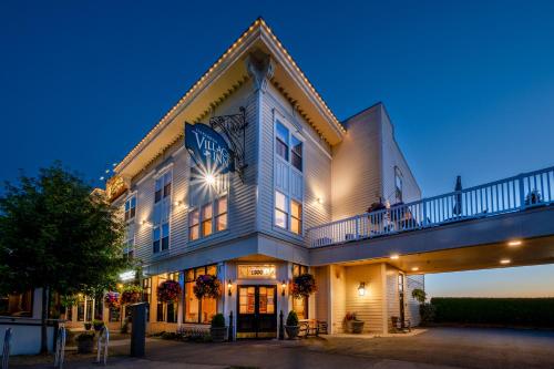 a large white building with people on the balcony at Fairhaven Village Inn in Bellingham