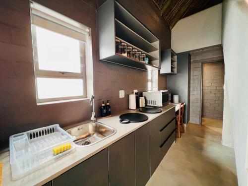a small kitchen with a sink and a window at Magical Mongoose in Jacobs Bay