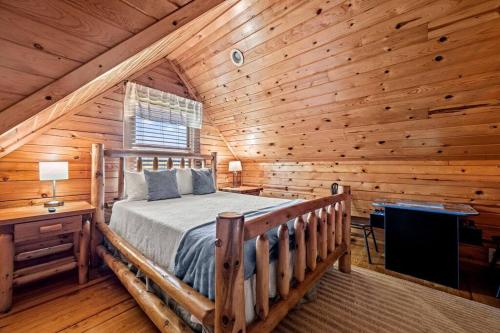 a bedroom with a bed in a log cabin at Pvt Pool at The Grotto in Sevierville