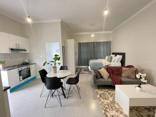 a living room with a couch and a table at Sunningdale White House Accomodations in Cape Town