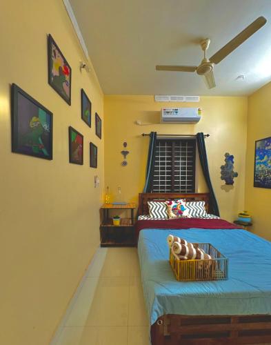 a bedroom with a bed with a basket on it at The Yellow Submarine in Varkala