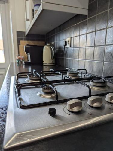 a kitchen with a stove top in a kitchen at Lovely 3-Bed Edinburgh Flat in Edinburgh
