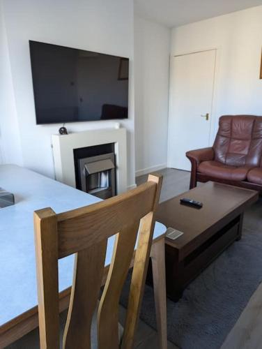 a living room with a table and a couch at Lovely 3-Bed Edinburgh Flat in Edinburgh