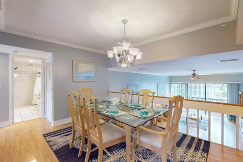 a dining room with a table and chairs at Our House at the Lake House C117 by Beachside in Siesta Key