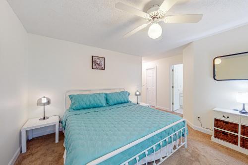 a bedroom with a bed and a ceiling fan at Seascape in Myrtle Beach