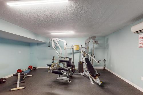 a gym with several tread machines in a room at Ocean Breeze Retreat in Daytona Beach