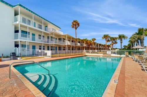 a swimming pool in front of a building at Ocean Breeze Retreat in Daytona Beach