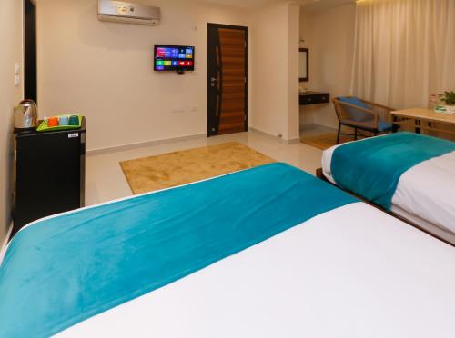 a hotel room with a bed and a tv at Diamond Pyramids View Inn in Cairo