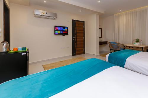 a hotel room with a bed and a tv at Diamond Pyramids View Inn in Cairo