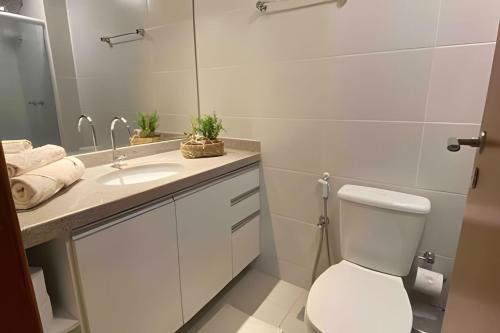 a bathroom with a toilet and a sink at Atlantis by Mosaico Stays in Vitória