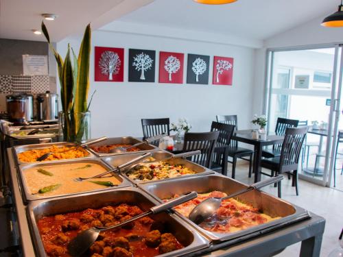 a buffet with several trays of food in a restaurant at Hotel St. George in Celaya