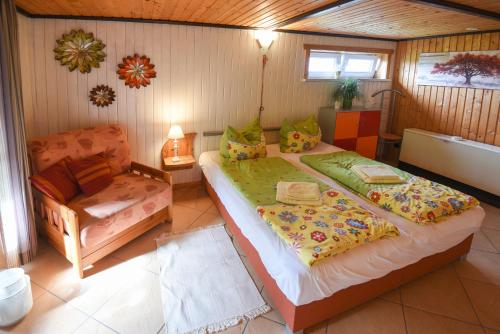 a bedroom with a large bed and a chair at Harzglück in Thale