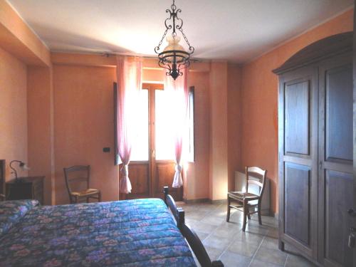 a bedroom with a bed and chairs and a window at Tenuta Montelaura in Forino