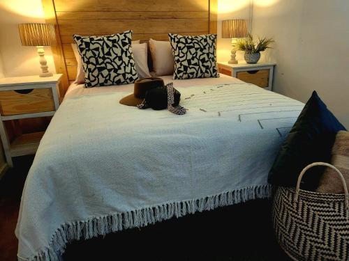 a large bed with a teddy bear laying on it at The Barn at Tembele in Dalmada AH