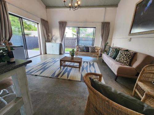 a living room with a couch and a table at The Barn at Tembele in Dalmada AH
