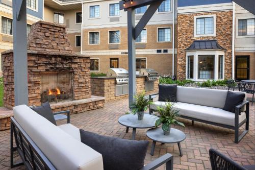 an outdoor patio with furniture and a fireplace at Staybridge Suites Minneapolis-Maple Grove by IHG in Maple Grove