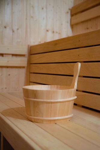 a wooden bowl sitting on top of a wooden table at Ostoja Narwiańska in Nagórki