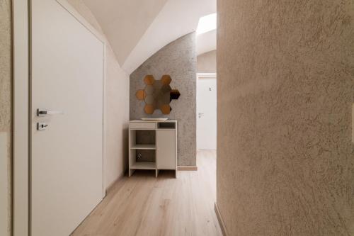 a hallway with white walls and a room with a table at Comfort Zone - Amalfi Coast in Maiori